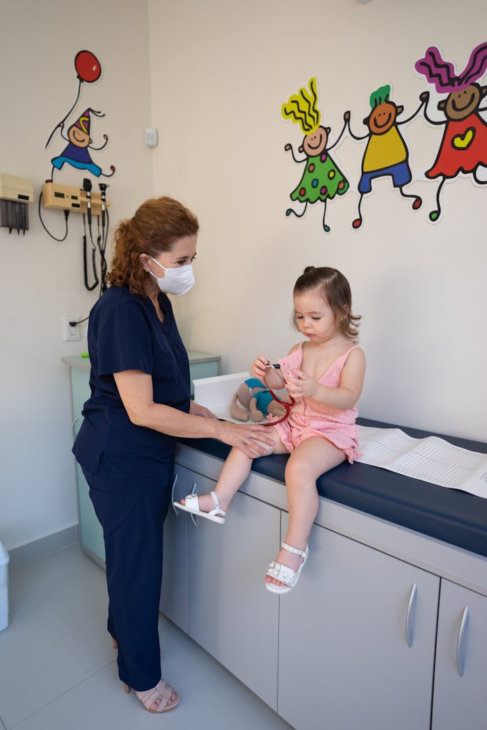 A child is examined by a nurse in a pediatrician's office, emphasizing gentle healthcare.